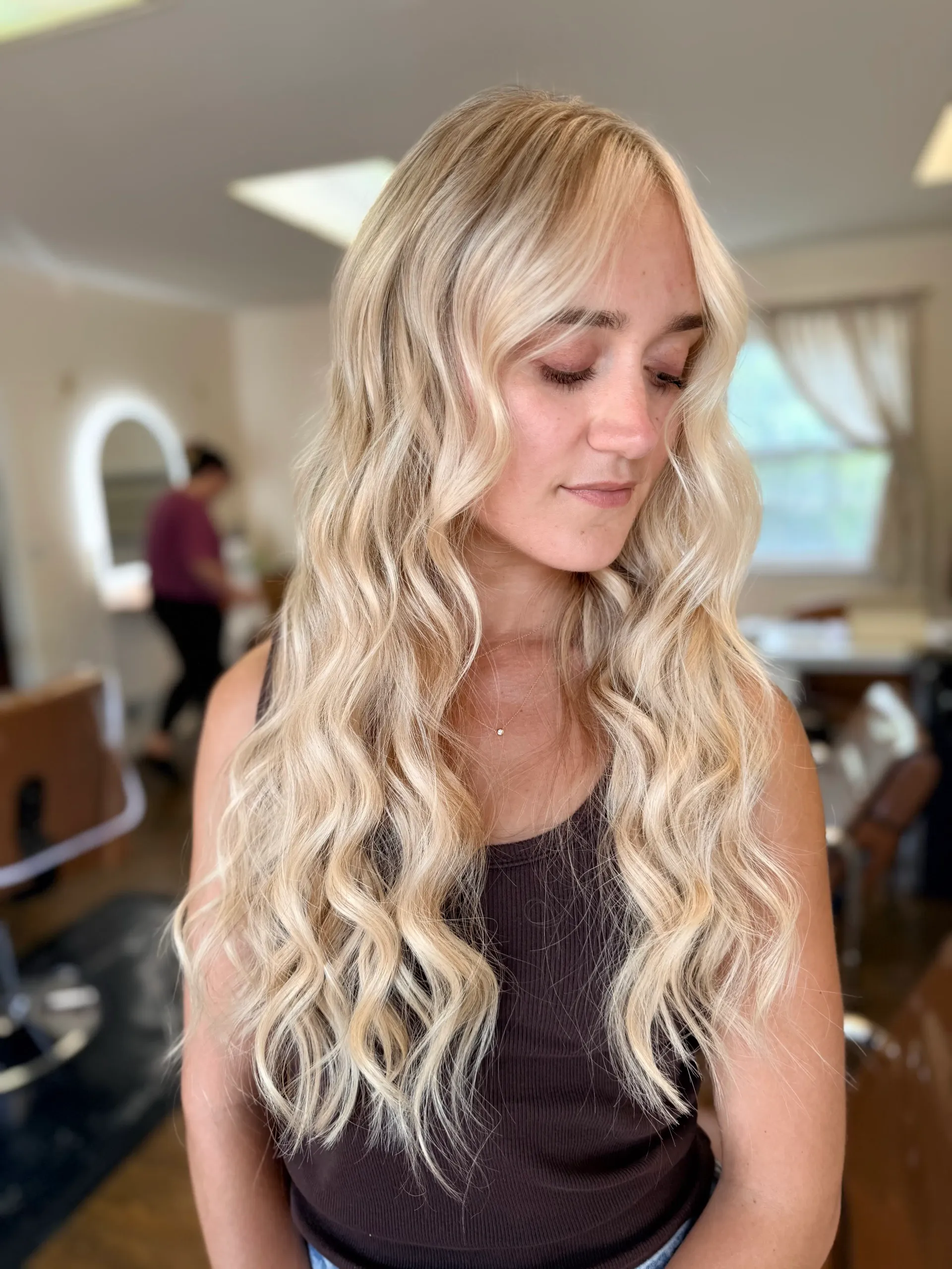 Long wavy bright blonde hair in a salon