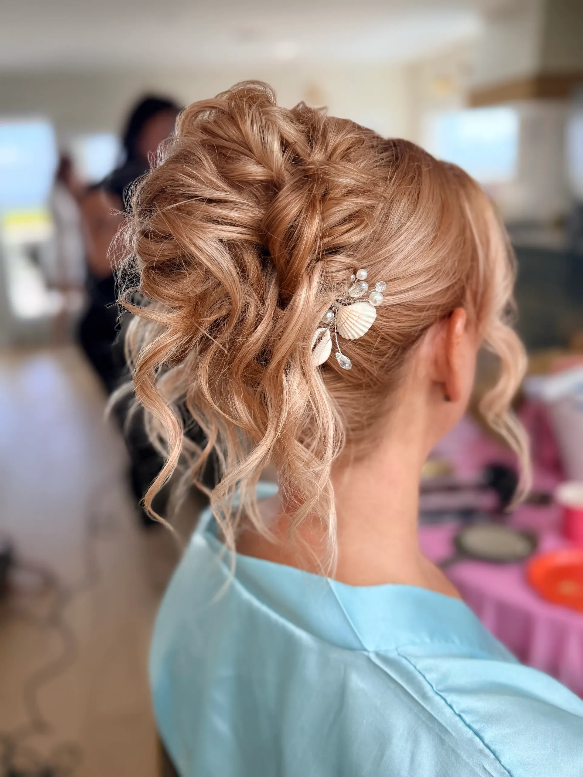 Soft curly blonde bridal updo with pearl and shell hair pins